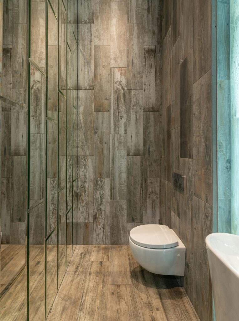 A modern bathroom with sleek design and wood paneling, emphasizing minimalism and elegance.